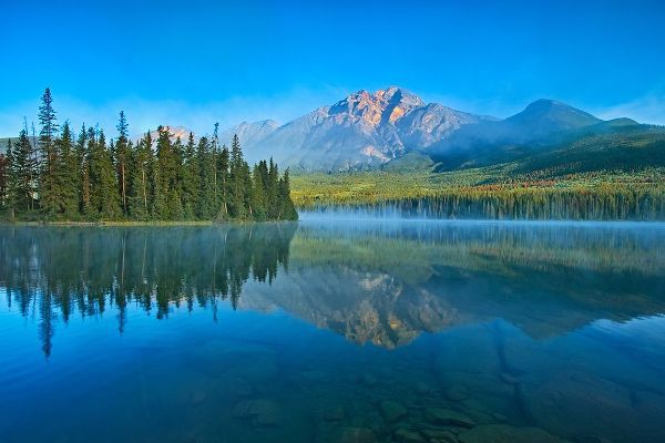 Canada-Alberta-Jasper National Park Mountain and forest reflections in lake